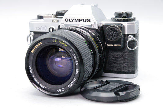 Olympus OM10 35mm SLR Camera + Miranda 35–70mm Lens + Manual Adapter + Batteries
