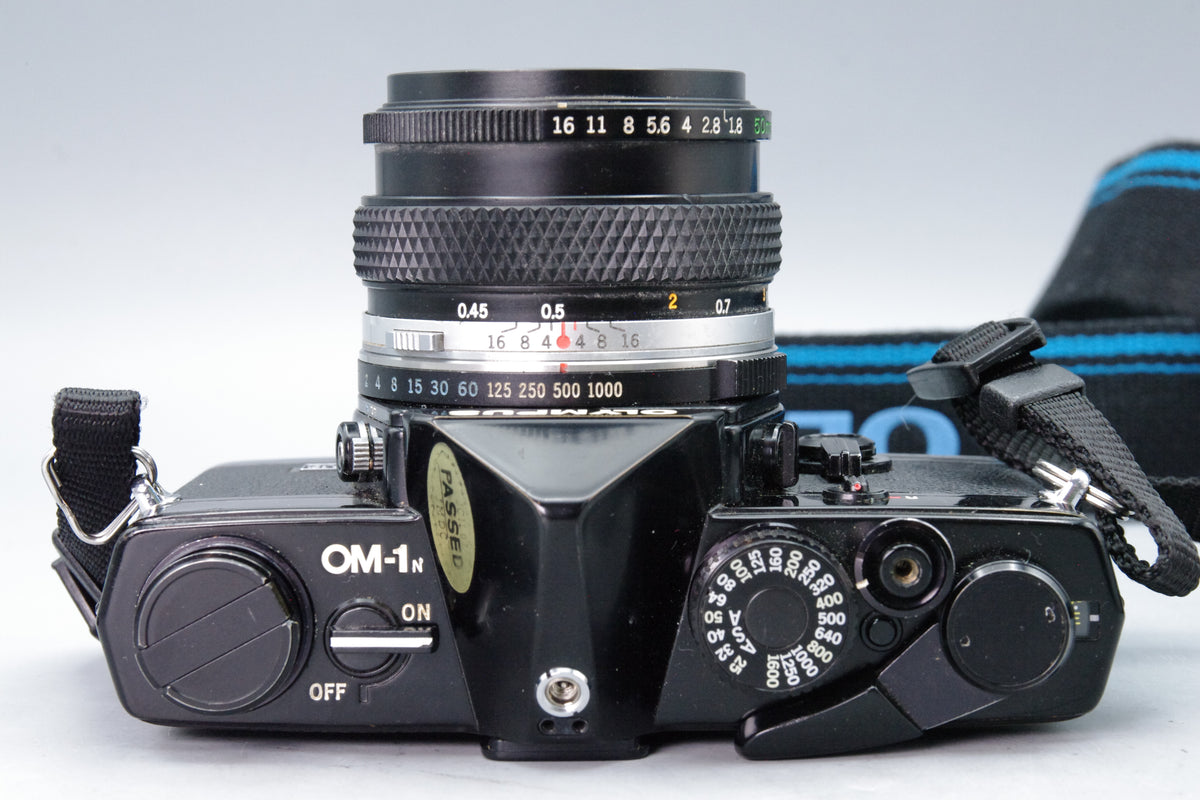 Olympus OM‑1N Black 35mm SLR Film Camera with Zuiko 50mm f/1.8 Lens – VGC