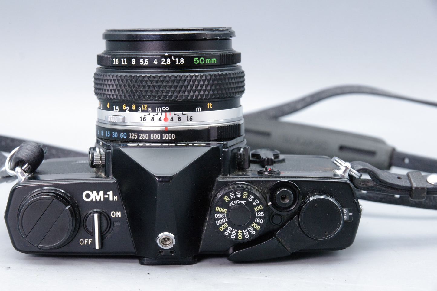 Olympus OM‑1N Black 35mm SLR Film Camera with Zuiko 50mm f/1.8 Lens – Excellent